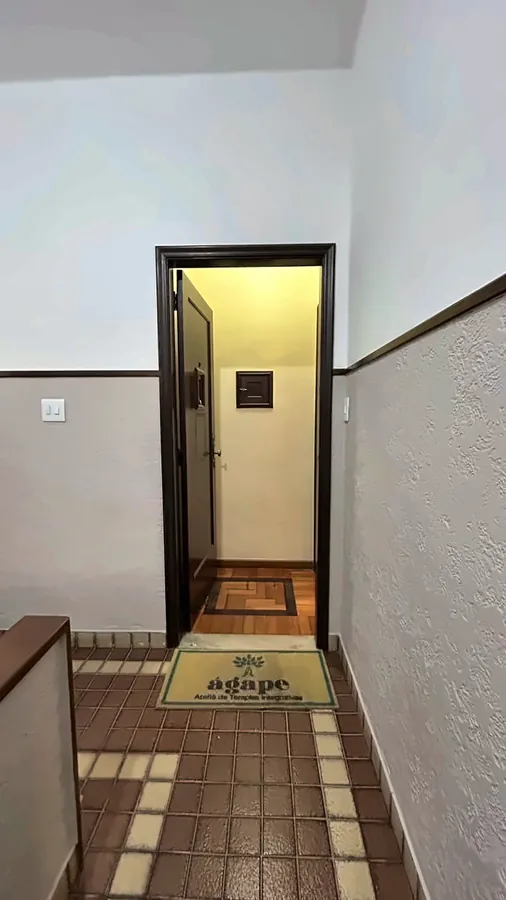 Corredor de entrada do Ágape, com o tapete da marca na porta.
